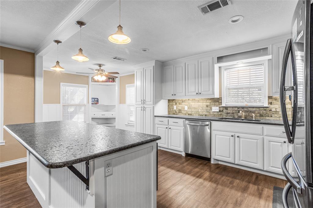 1825 North Highland Avenue Sherman, TX 75092 - Photo 16 of 38 a kitchen with granite countertop cabinets sink and window