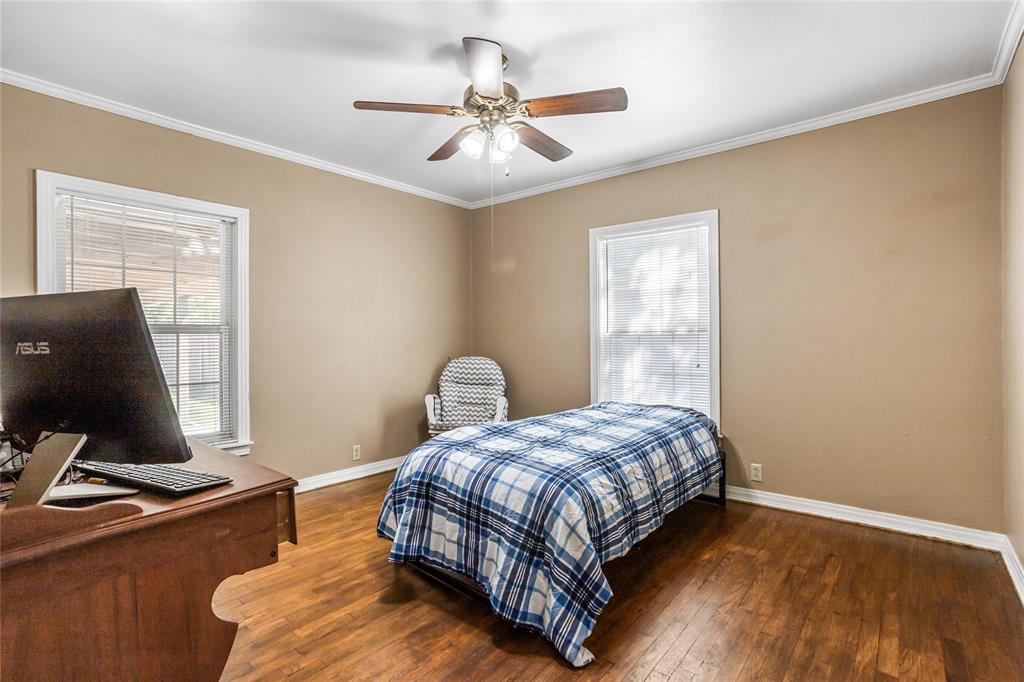 1825 North Highland Avenue Sherman, TX 75092 - Photo 26 of 38 a bedroom with a bed window and a desk
