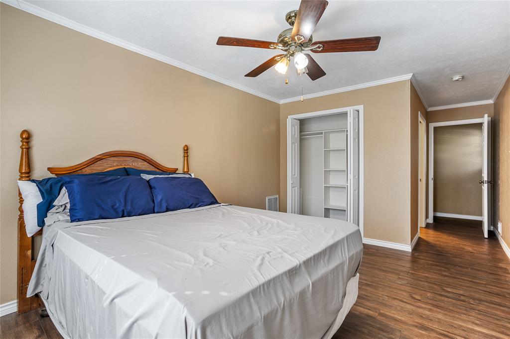 1825 North Highland Avenue Sherman, TX 75092 - Photo 28 of 38 a bedroom with a bed and a chandelier