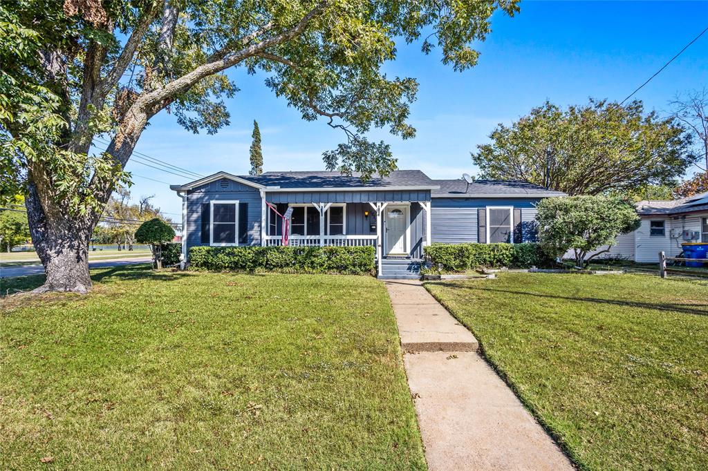 1825 North Highland Avenue Sherman, TX 75092 - Photo 3 of 38 a front view of a house with a yard