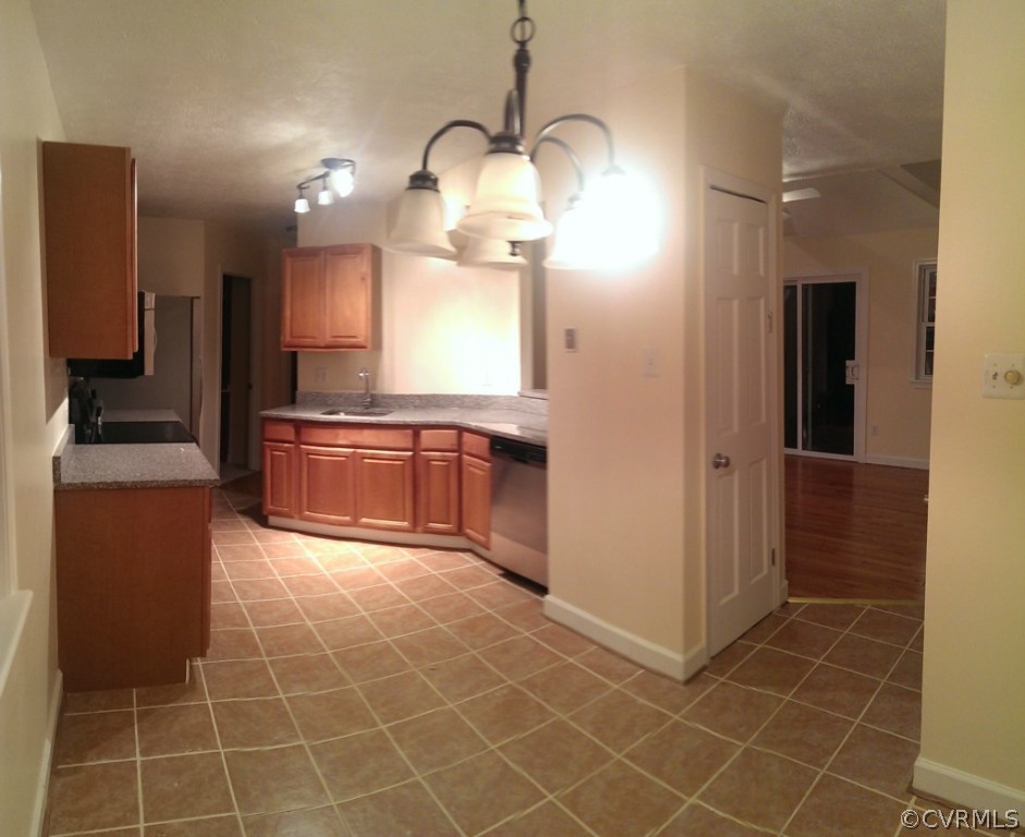 7748 Drexelbrook Road Chesterfield, VA 23832 - Photo 5 of 16 a large kitchen with granite countertop a sink and a stove top oven