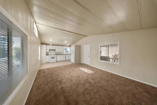 en empty room with windows and cabinet