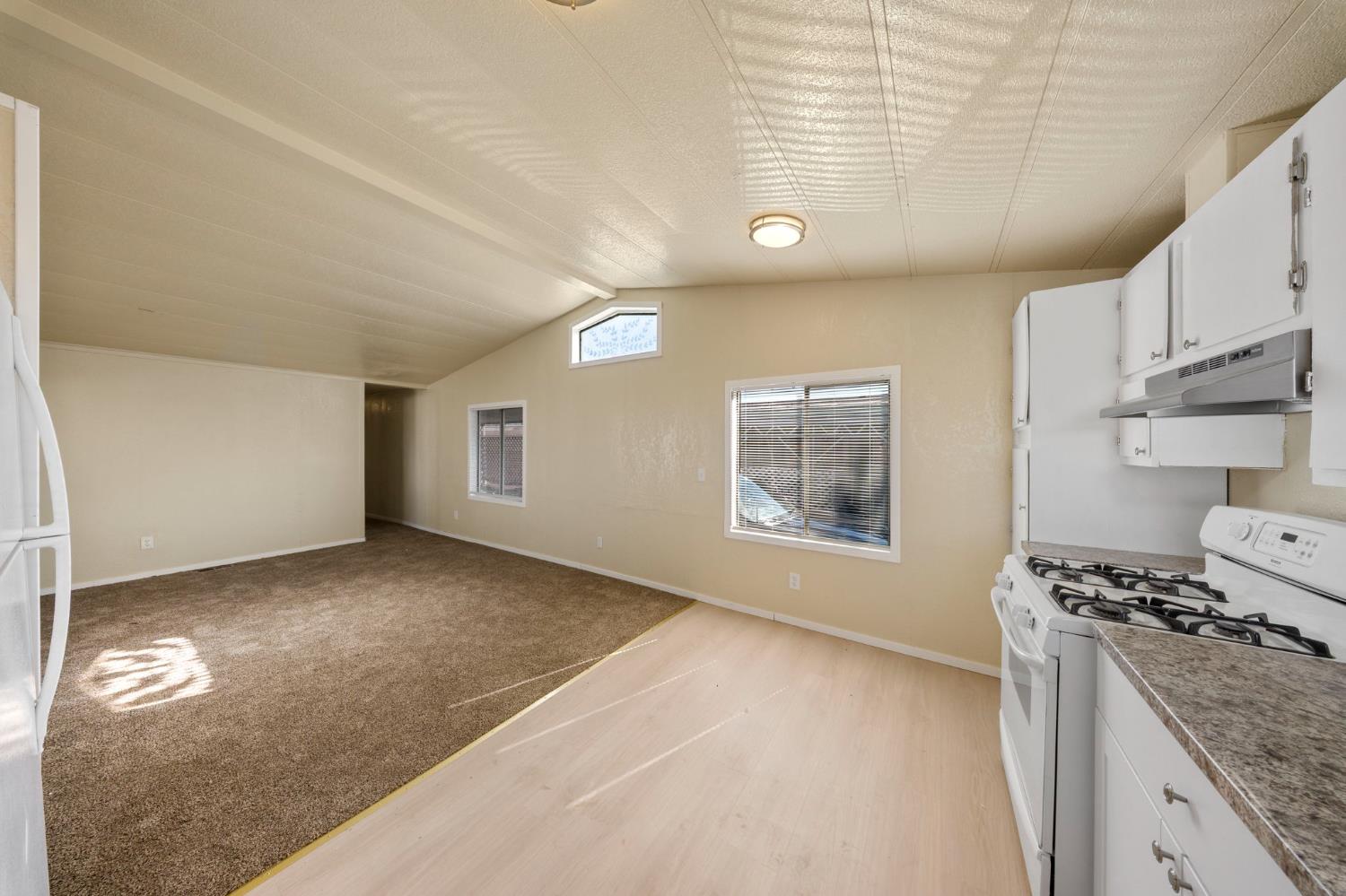 3550 Mitchell Road, Unit 59 Ceres, CA 95307 - Photo 9 of 18 a kitchen with stainless steel appliances granite countertop a stove a sink and a refrigerator