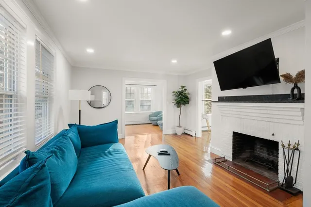 a living room with furniture a fireplace and a flat screen tv