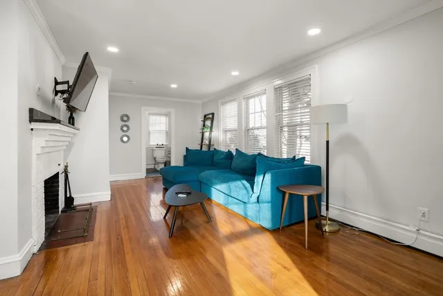 a bathroom with a granite countertop toilet a sink and a window