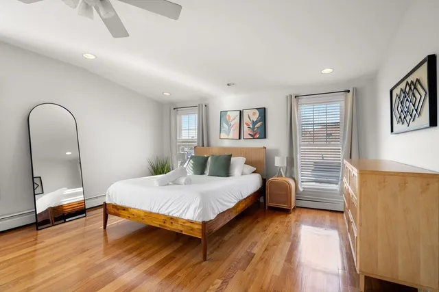 a bedroom with a bed and wooden floor