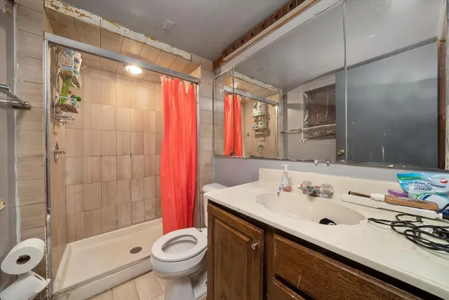 a bathroom with a sink toilet and shower
