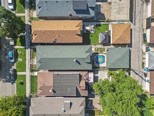 an aerial view of houses with street