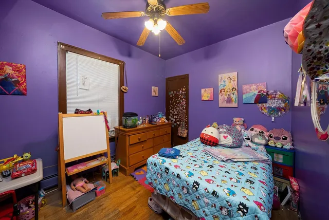 a bedroom with a bed and a dresser in it