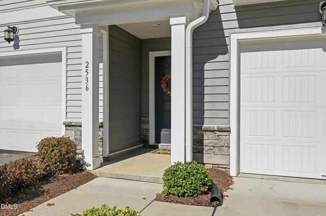 a couple of potted plants in front of door
