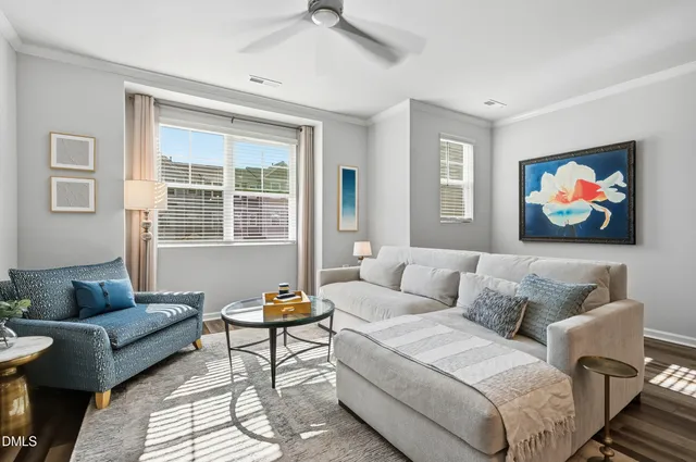 a living room with furniture a couch and two window