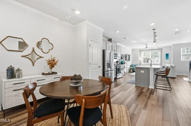 a view of a dining room with furniture and wooden floor