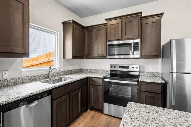 a kitchen with a sink stove and refrigerator