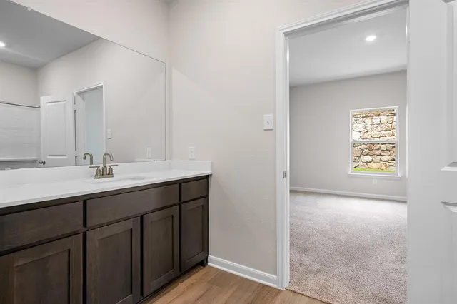 a bathroom with a sink a mirror and a window