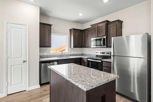 a kitchen with a refrigerator stove and sink
