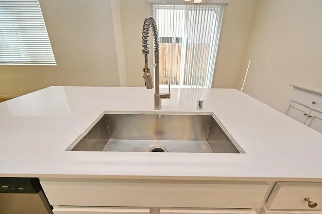 a large kitchen with cabinets and stainless steel appliances
