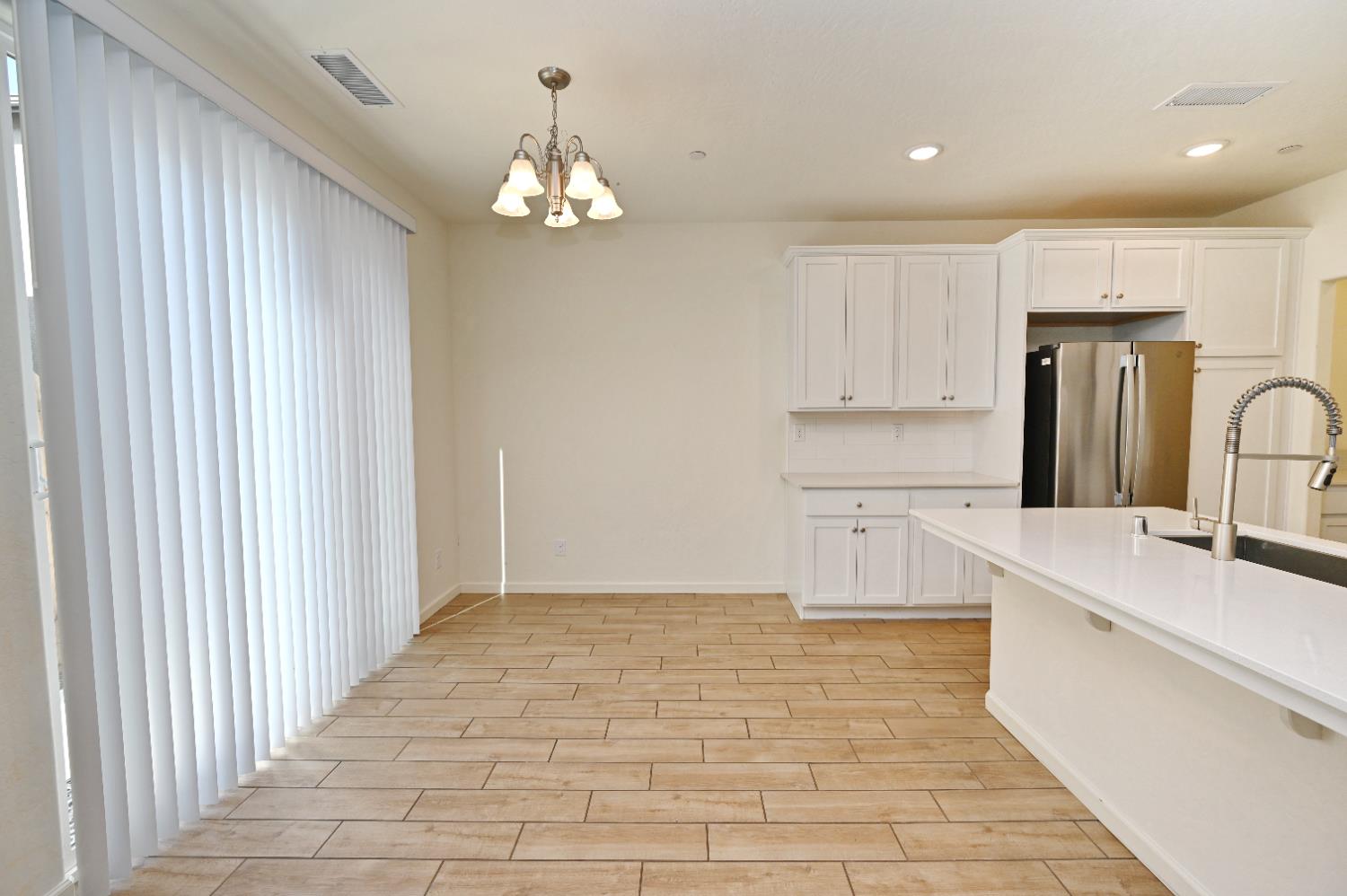 2273 North Raleigh Drive Fresno, CA 93727 - Photo 13 of 29 a large kitchen with cabinets and stainless steel appliances