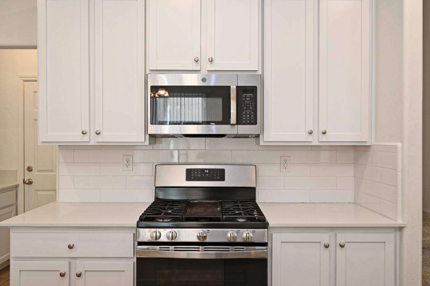 2273 North Raleigh Drive Fresno, CA 93727 - Photo 14 of 29 a kitchen with cabinets stainless steel appliances and a counter space