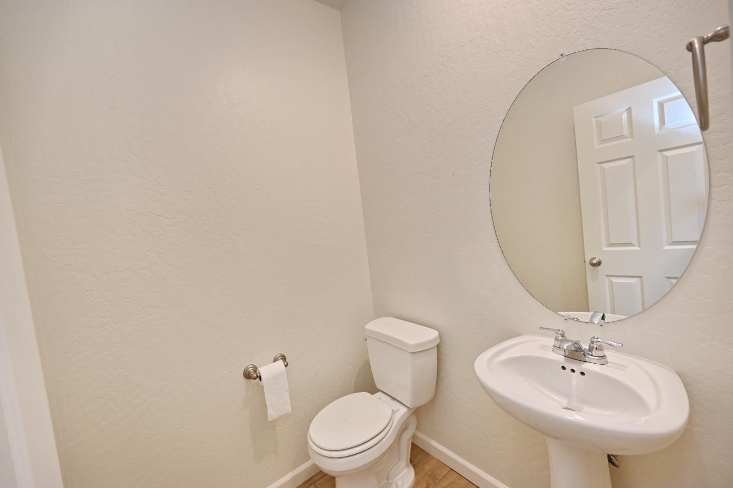2273 North Raleigh Drive Fresno, CA 93727 - Photo 15 of 29 a bathroom with a sink a toilet and mirror