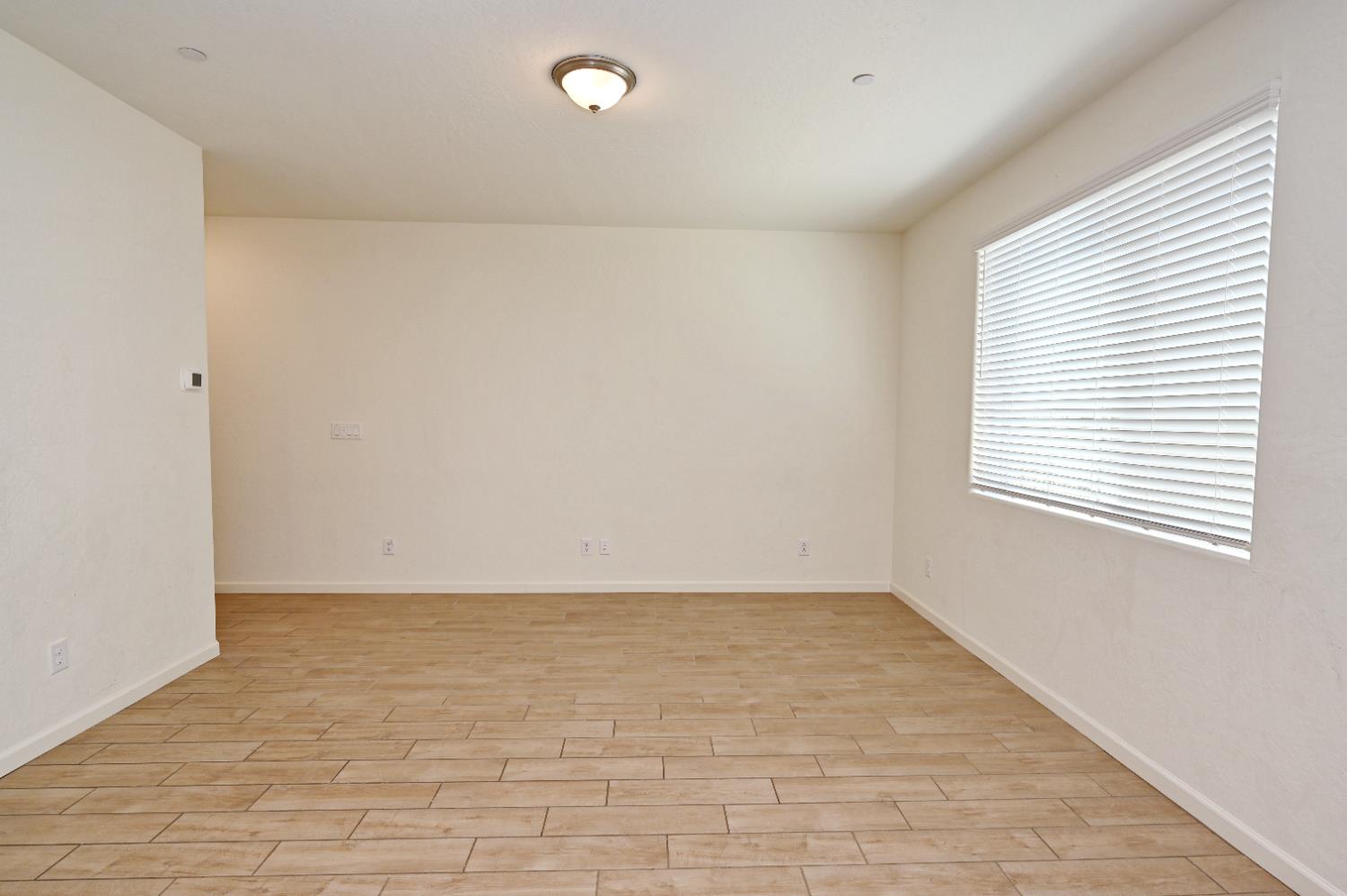 2273 North Raleigh Drive Fresno, CA 93727 - Photo 16 of 29 a view of an empty room with a window