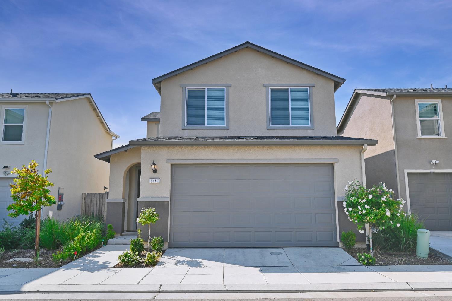 2273 North Raleigh Drive Fresno, CA 93727 - Photo 2 of 29 a front view of a house with plants