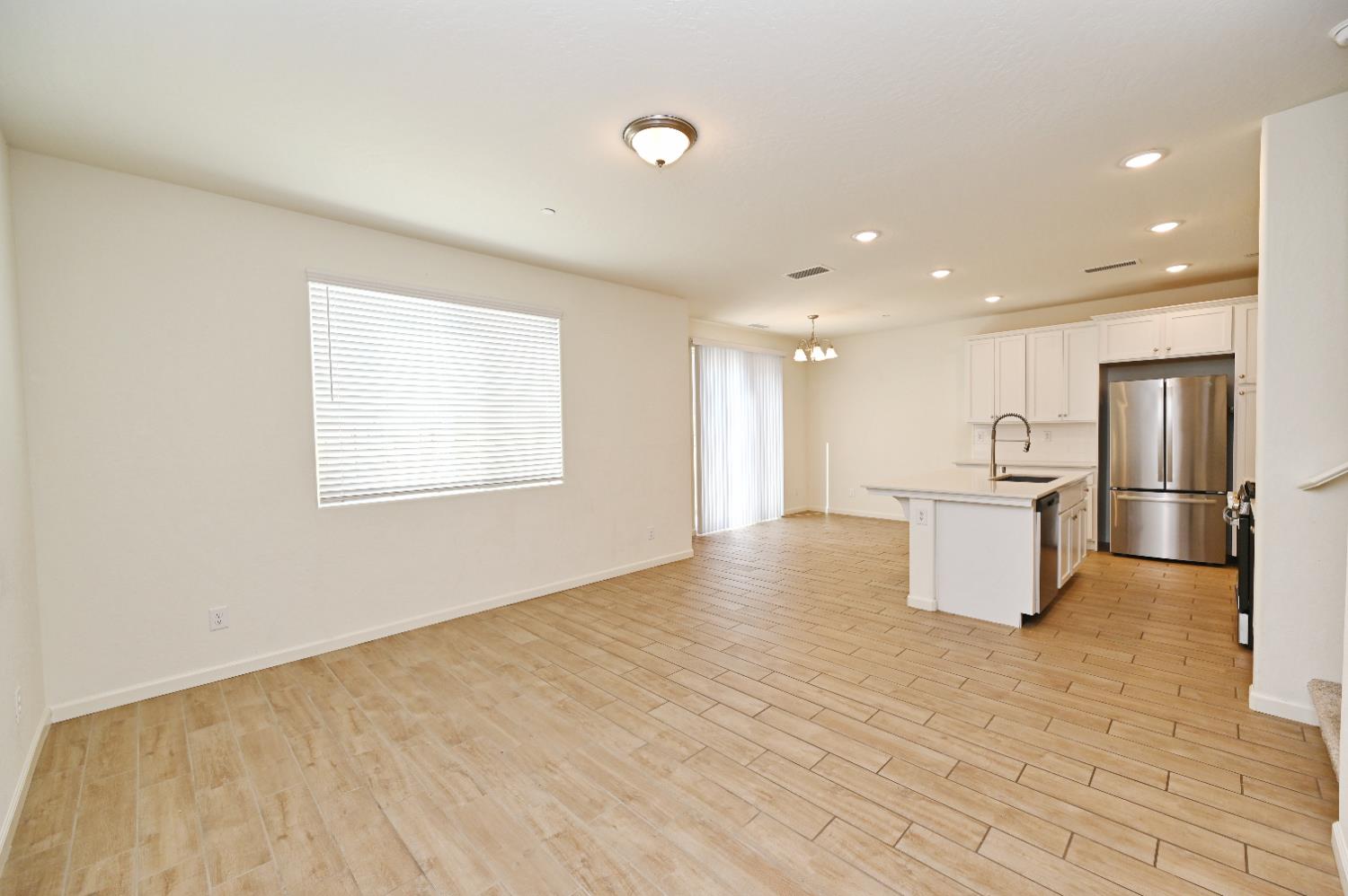 2273 North Raleigh Drive Fresno, CA 93727 - Photo 22 of 29 a view of kitchen with kitchen island a sink wooden floor and counter top space