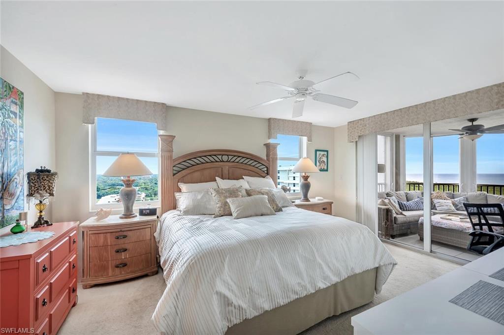 6573 Marissa Loop, Unit 1704 Naples, FL 34108 - Photo 11 of 39 a bedroom with a large bed and a large window with the outer view