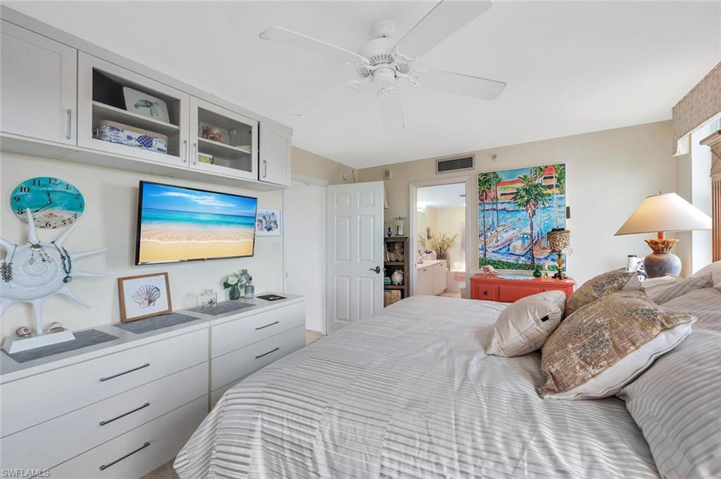 6573 Marissa Loop, Unit 1704 Naples, FL 34108 - Photo 13 of 39 a bedroom with a large bed and a window