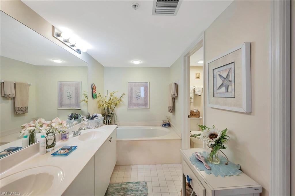 6573 Marissa Loop, Unit 1704 Naples, FL 34108 - Photo 14 of 39 a white bath tub sitting next to a bathroom sink