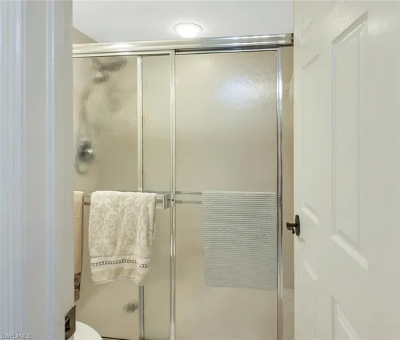 a bathroom with a glass shower door