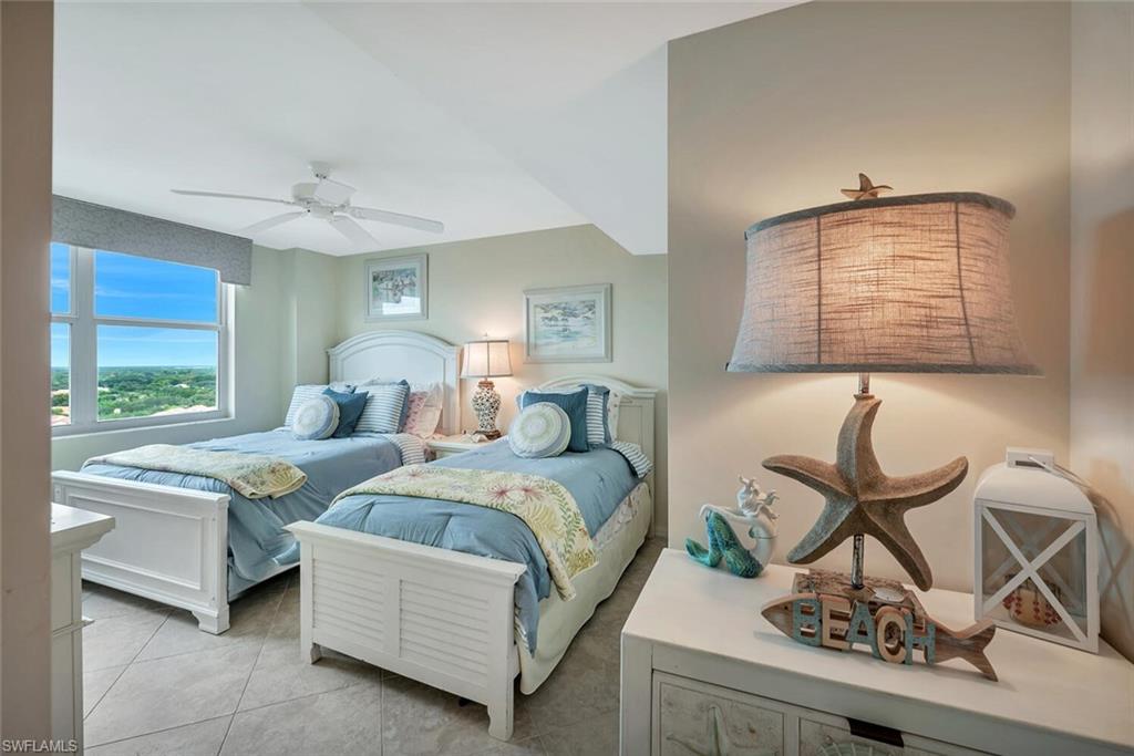 6573 Marissa Loop, Unit 1704 Naples, FL 34108 - Photo 20 of 39 a bedroom with a bed window and chair