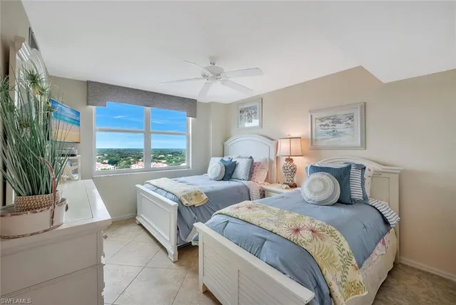 a bedroom with large bed and a large window