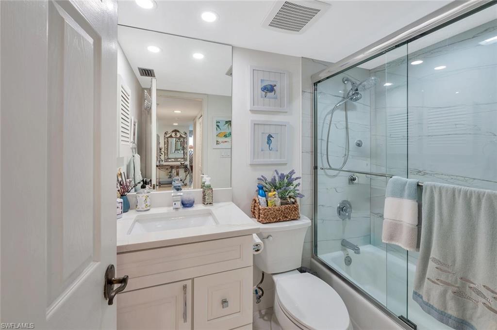 6573 Marissa Loop, Unit 1704 Naples, FL 34108 - Photo 22 of 39 a bathroom with a sink toilet and shower