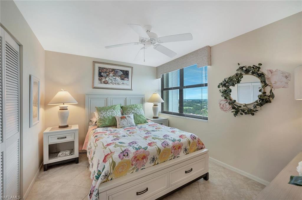 6573 Marissa Loop, Unit 1704 Naples, FL 34108 - Photo 23 of 39 a bedroom with a bed and a window