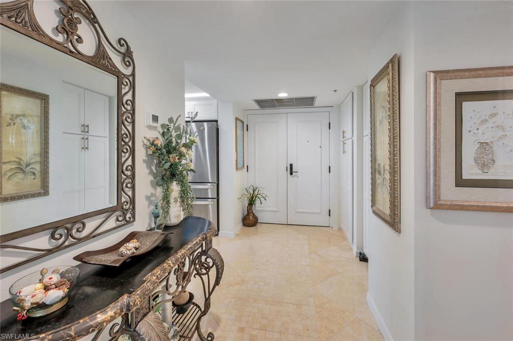 6573 Marissa Loop, Unit 1704 Naples, FL 34108 - Photo 25 of 39 a bathroom with a sink a mirror and a shower
