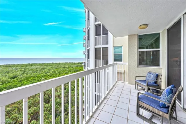 a view of a balcony with chair and wooden floor