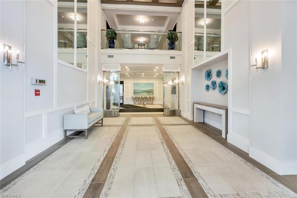 6573 Marissa Loop, Unit 1704 Naples, FL 34108 - Photo 30 of 39 a view of a living room with a fireplace