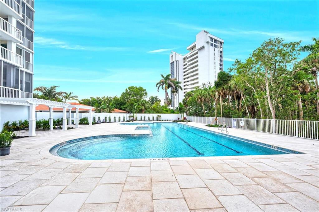 6573 Marissa Loop, Unit 1704 Naples, FL 34108 - Photo 32 of 39 a view of a swimming pool with a lounge chairs