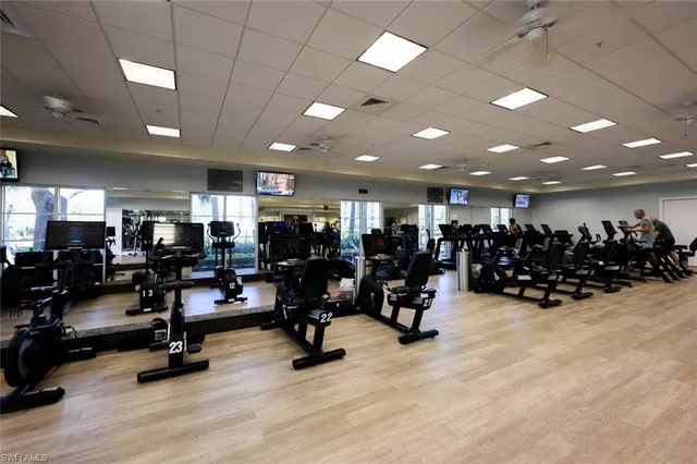 a view of a room with gym equipment and lots of equipment