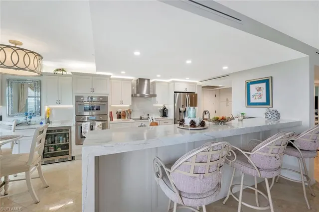 a view of a dining room kitchen and a chandelier