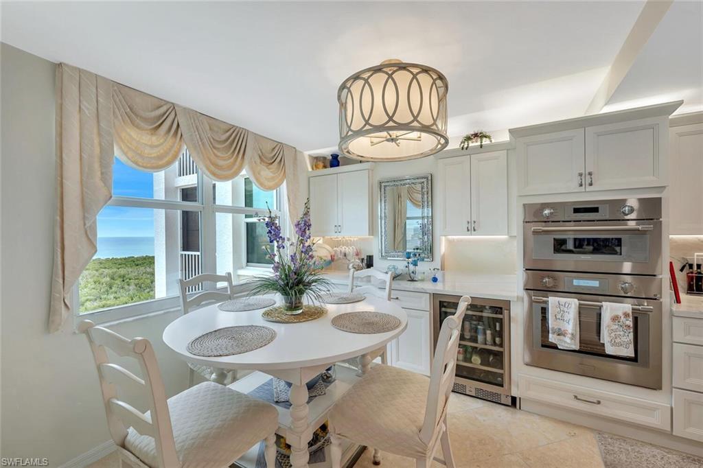 6573 Marissa Loop, Unit 1704 Naples, FL 34108 - Photo 7 of 39 a view of a dining room with furniture a chandelier and wooden floor