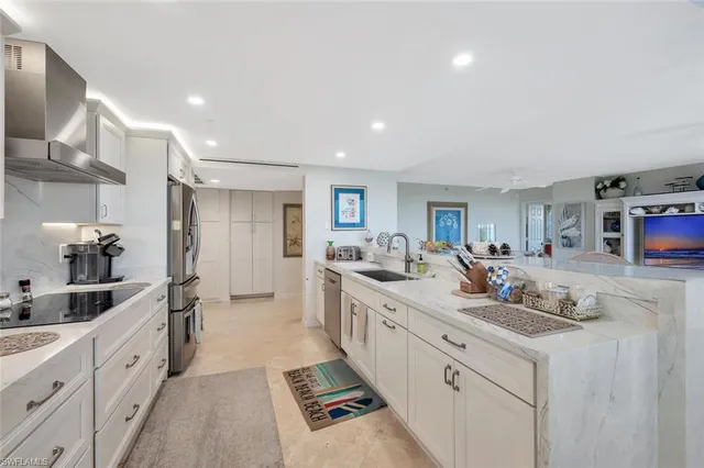 a kitchen with sink stove and cabinets