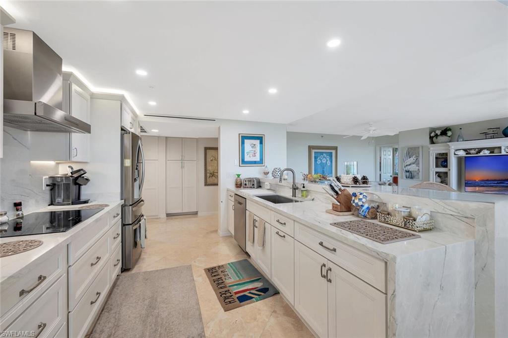 6573 Marissa Loop, Unit 1704 Naples, FL 34108 - Photo 8 of 39 a kitchen with sink stove and cabinets