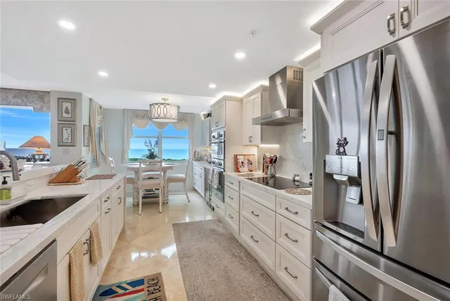 a kitchen with stainless steel appliances granite countertop refrigerator sink and cabinets