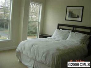 4136 Walker Road, Unit 4136 Charlotte, NC 28211 - Photo 6 of 8 a bedroom with a bed and a painting on the wall