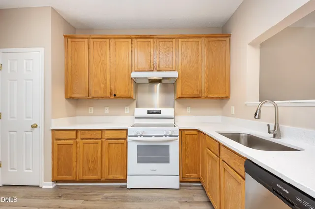 a kitchen with a sink stove and cabinets