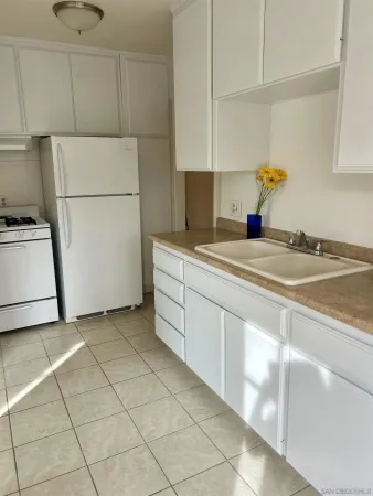 a utility room with cabinets washer and dryer