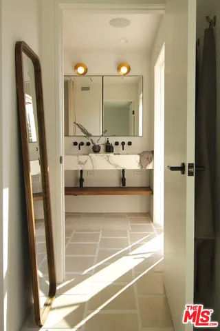a bathroom with a bathtub sink and mirror