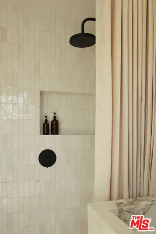 a view of a bathroom with a bathtub and window