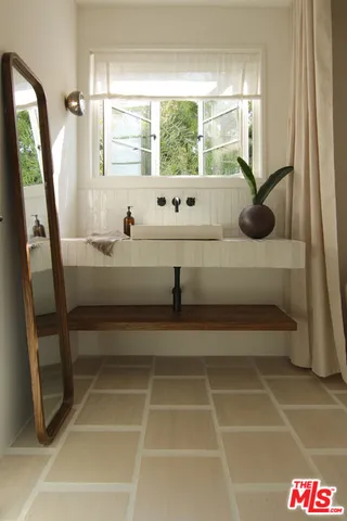 a room way with furniture and a potted plant